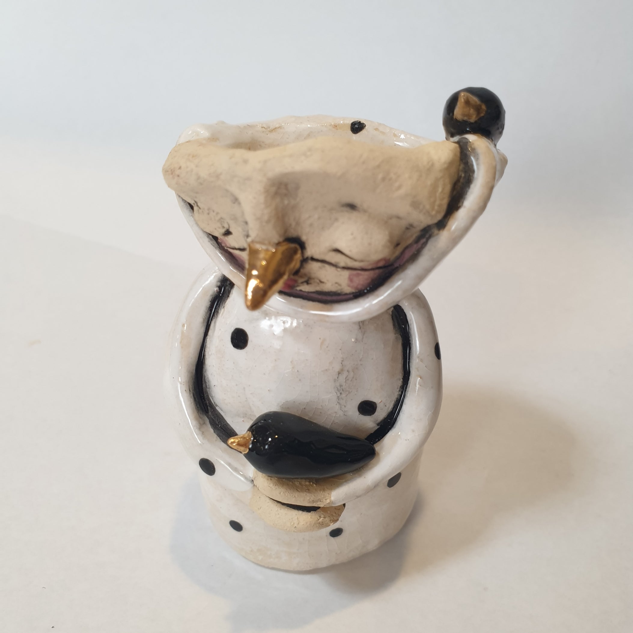 little clay character, birds and dots