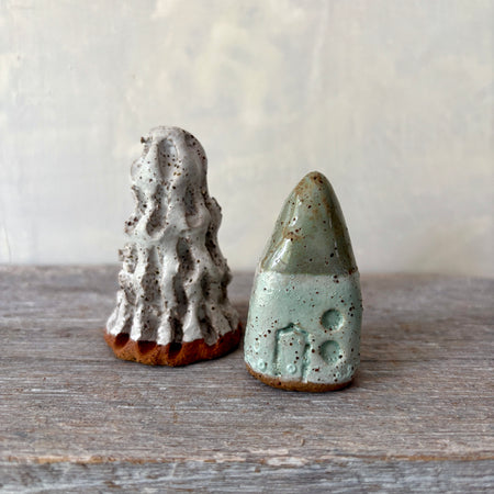 A cute tiny cottage with a little tree