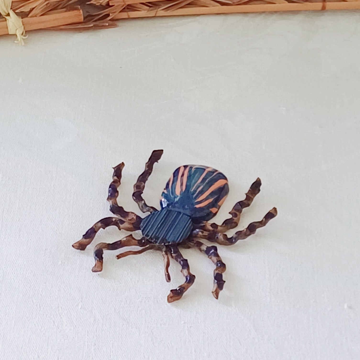 Hand painted blue palm leaf clay spider keepsake with magnet
