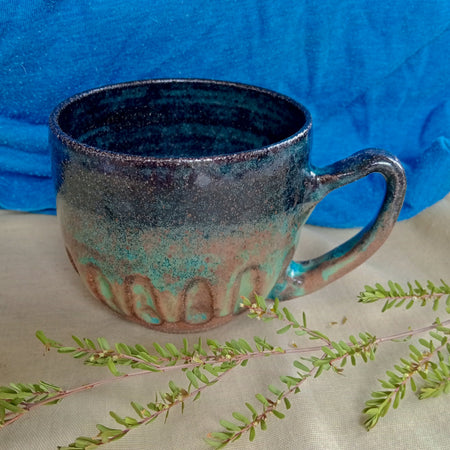 Blue & teal mug on rustic dark clay