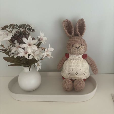 Little hand knitted bunny in removable red dress