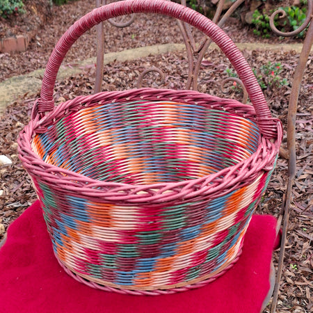 Large Round Market Basket brown, blue, orange, red and natural. Handle brown.