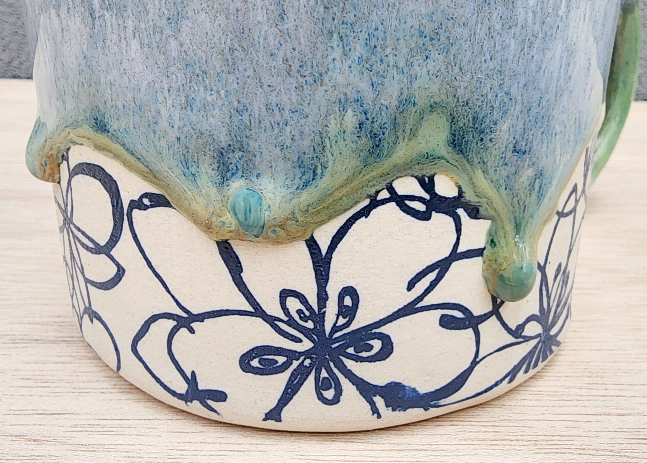 Ceramic floral mug with drippy glaze