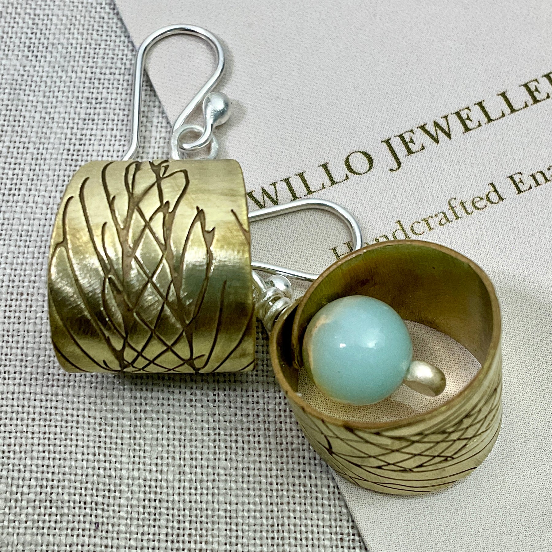 Embossed brass earrings with gemstones.
