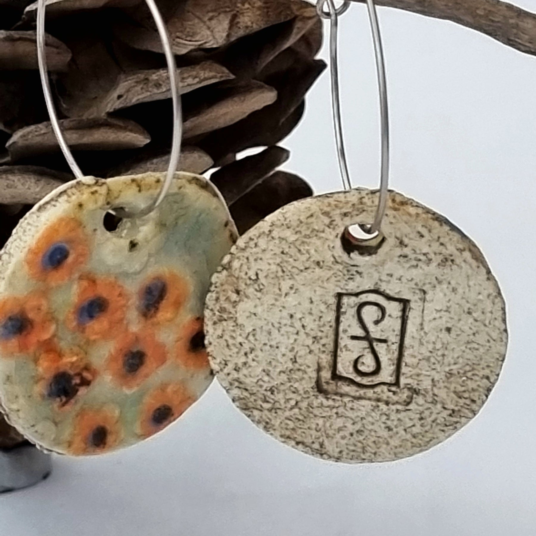 Handmade Stoneware Ceramic Earrings, orange floral multi-coloured, 28mm diameter, pierced ears