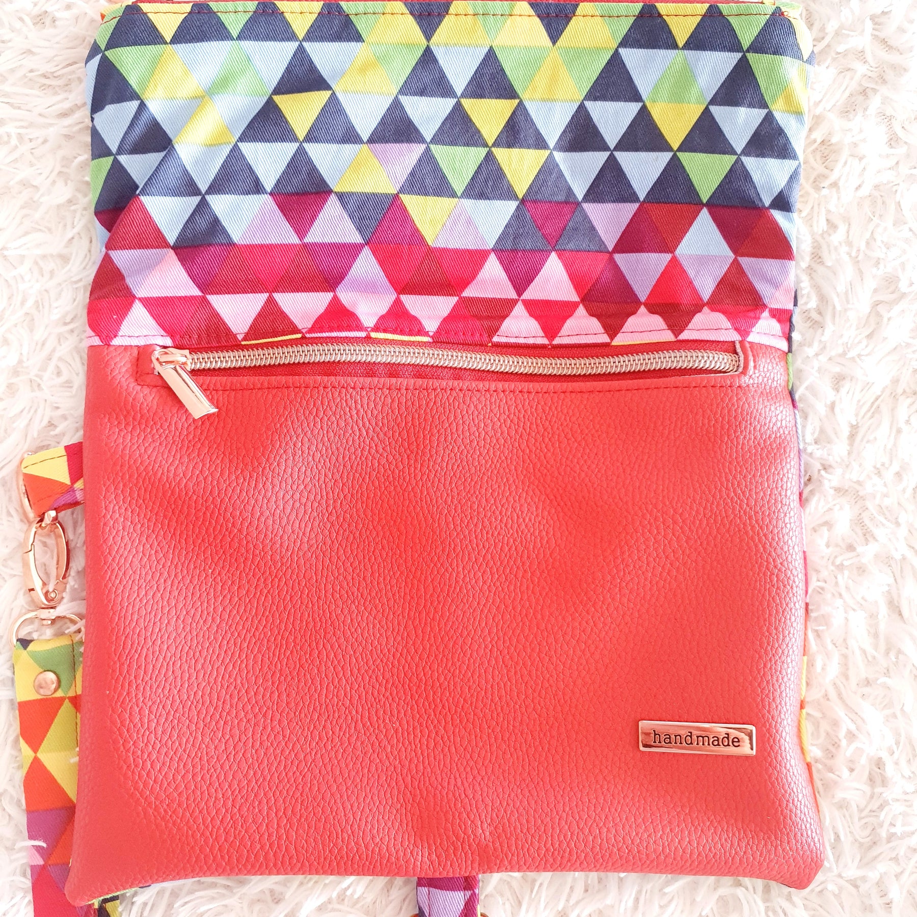 Multi colored red modern fold over zipper clutch with detachable strap