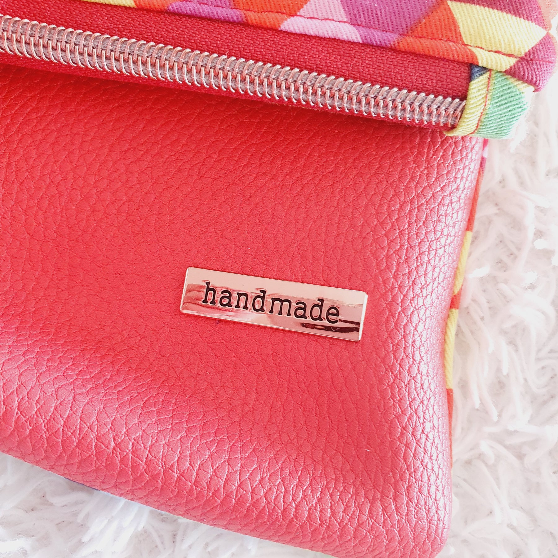 Multi colored red modern fold over zipper clutch with detachable strap