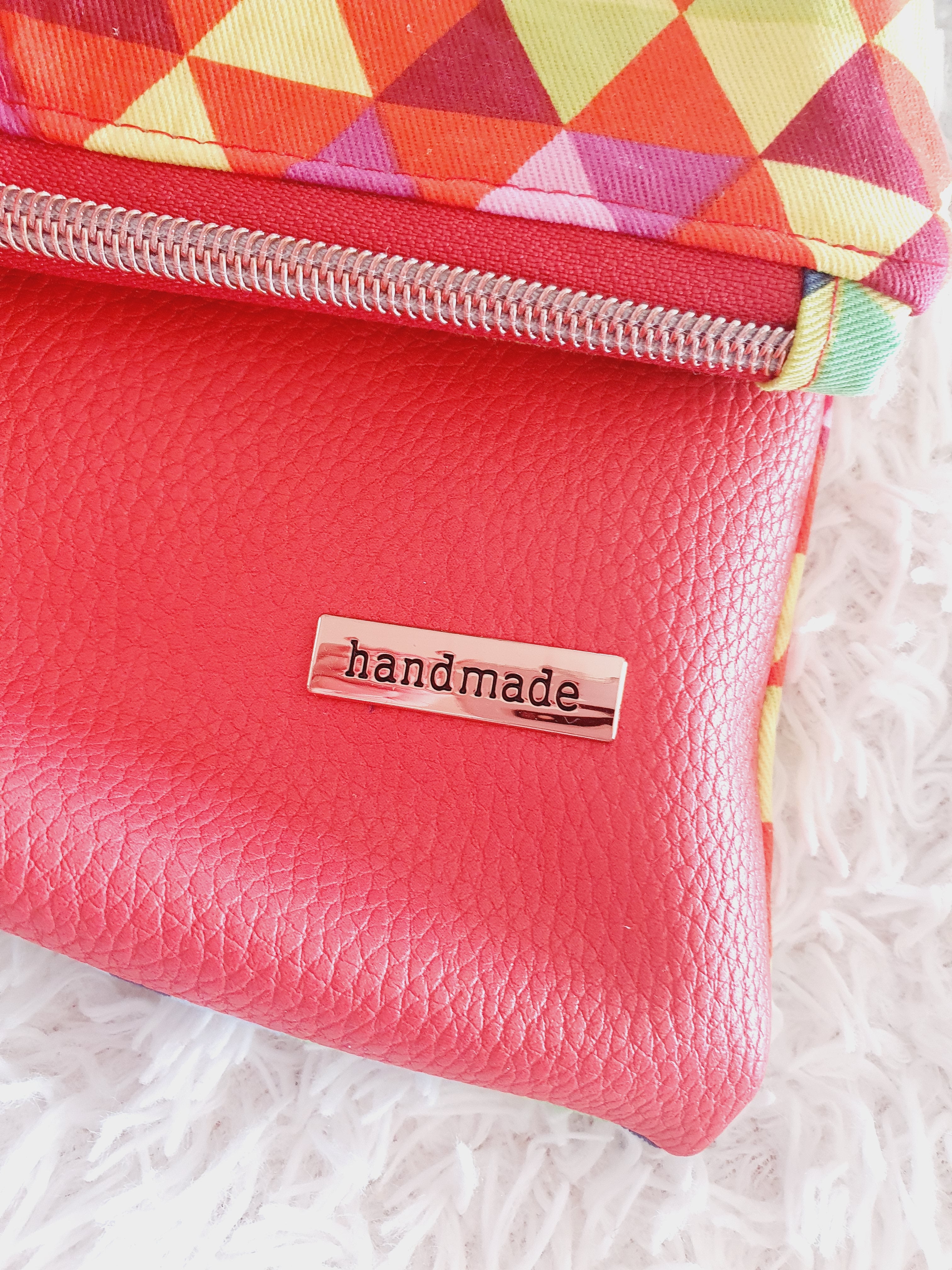 Multi colored red modern fold over zipper clutch with detachable strap