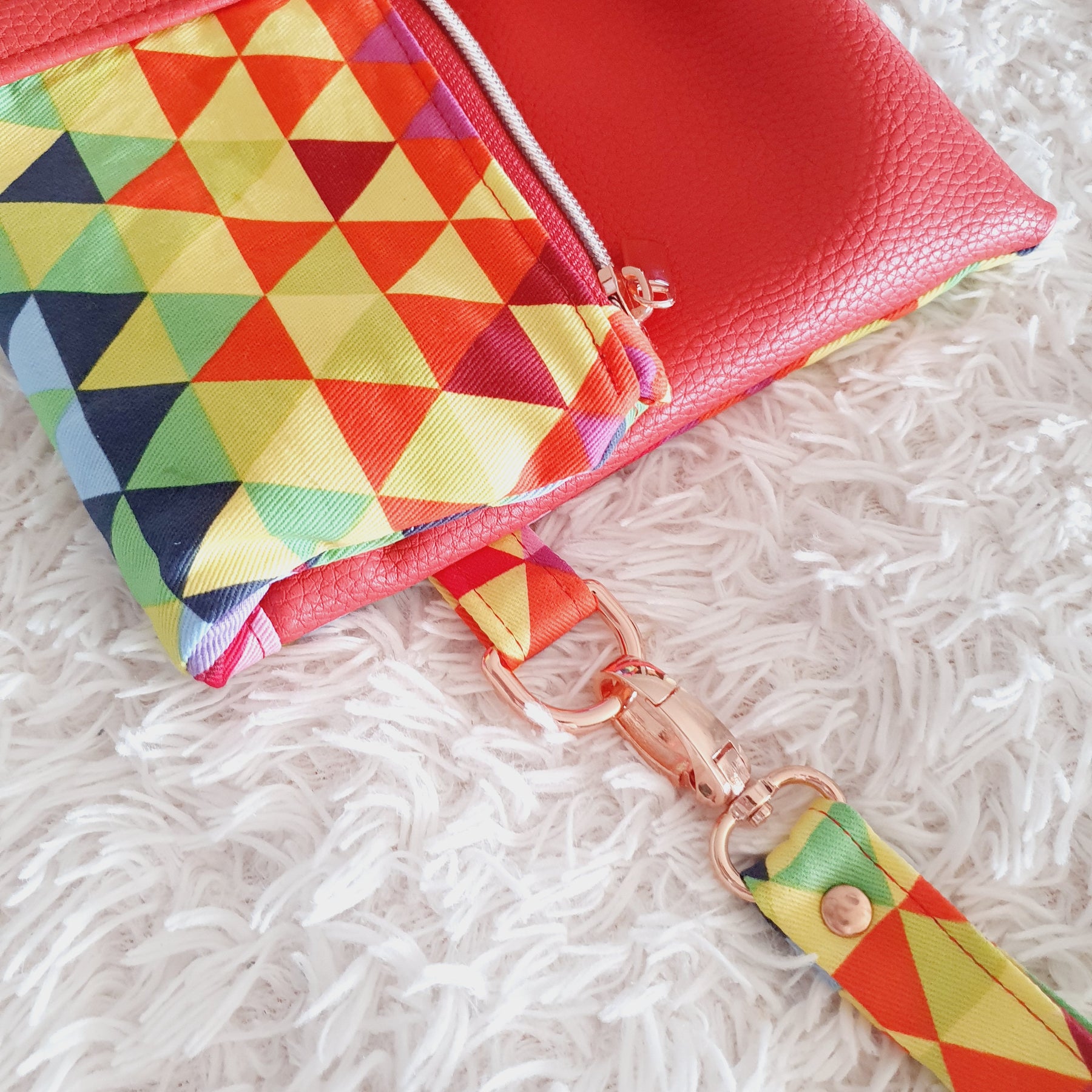 Multi colored red modern fold over zipper clutch with detachable strap