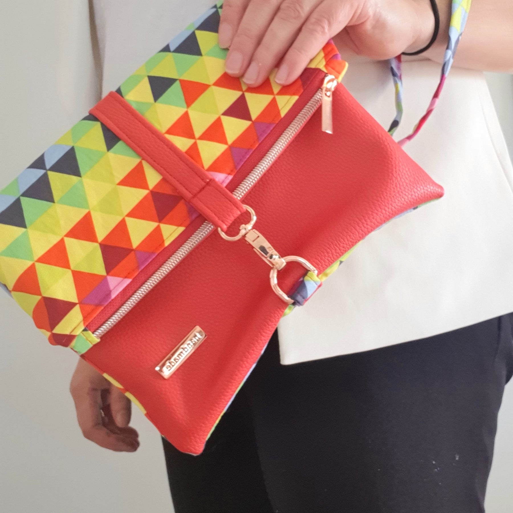 Multi colored red modern fold over zipper clutch with detachable strap