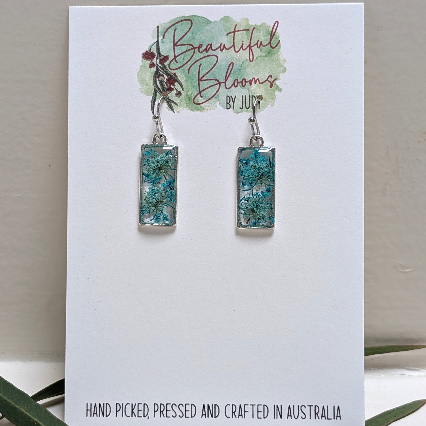 Rectangular silver earrings with teal Queen Anne's Lace