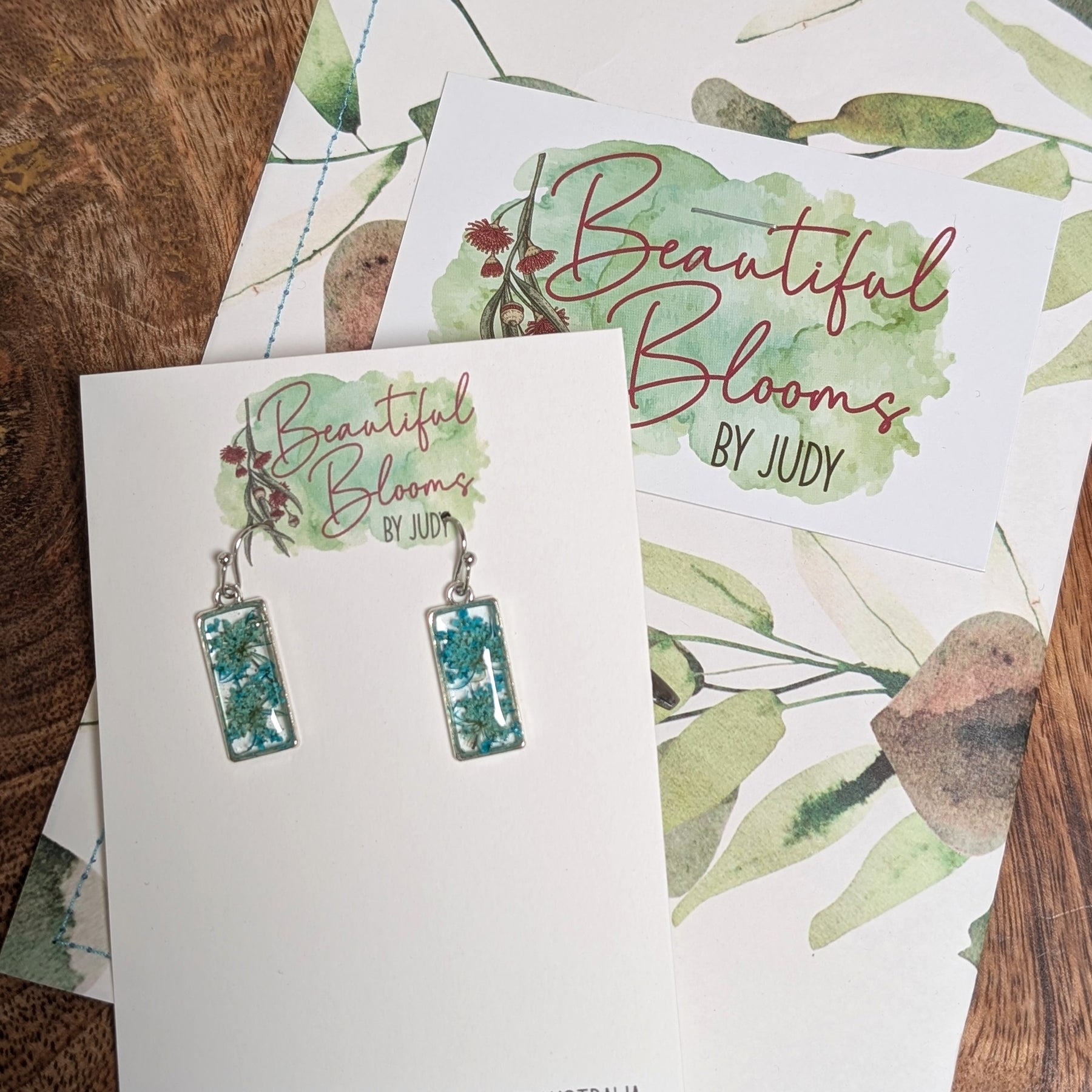 Rectangular silver earrings with teal Queen Anne's Lace