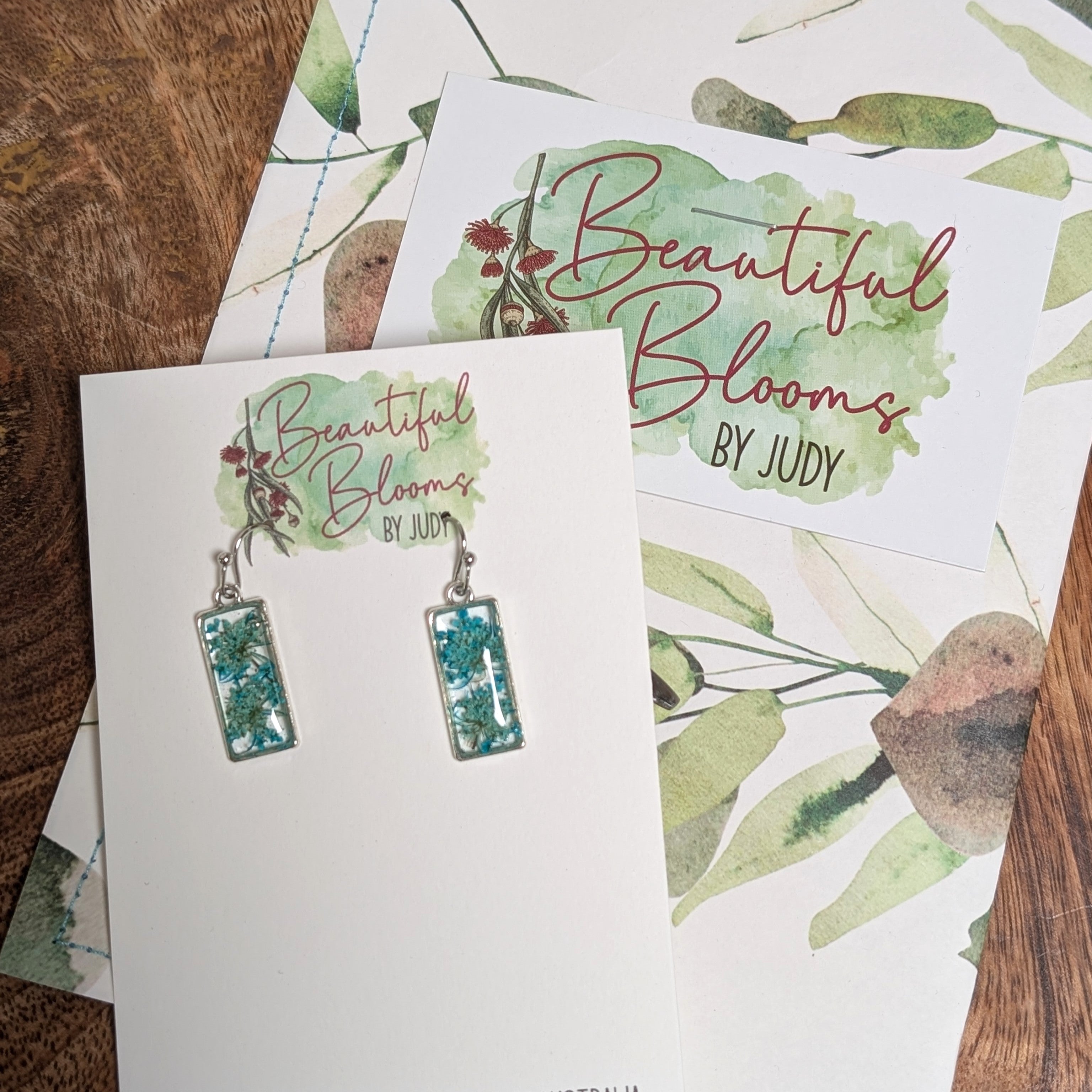 Rectangular silver earrings with teal Queen Anne's Lace