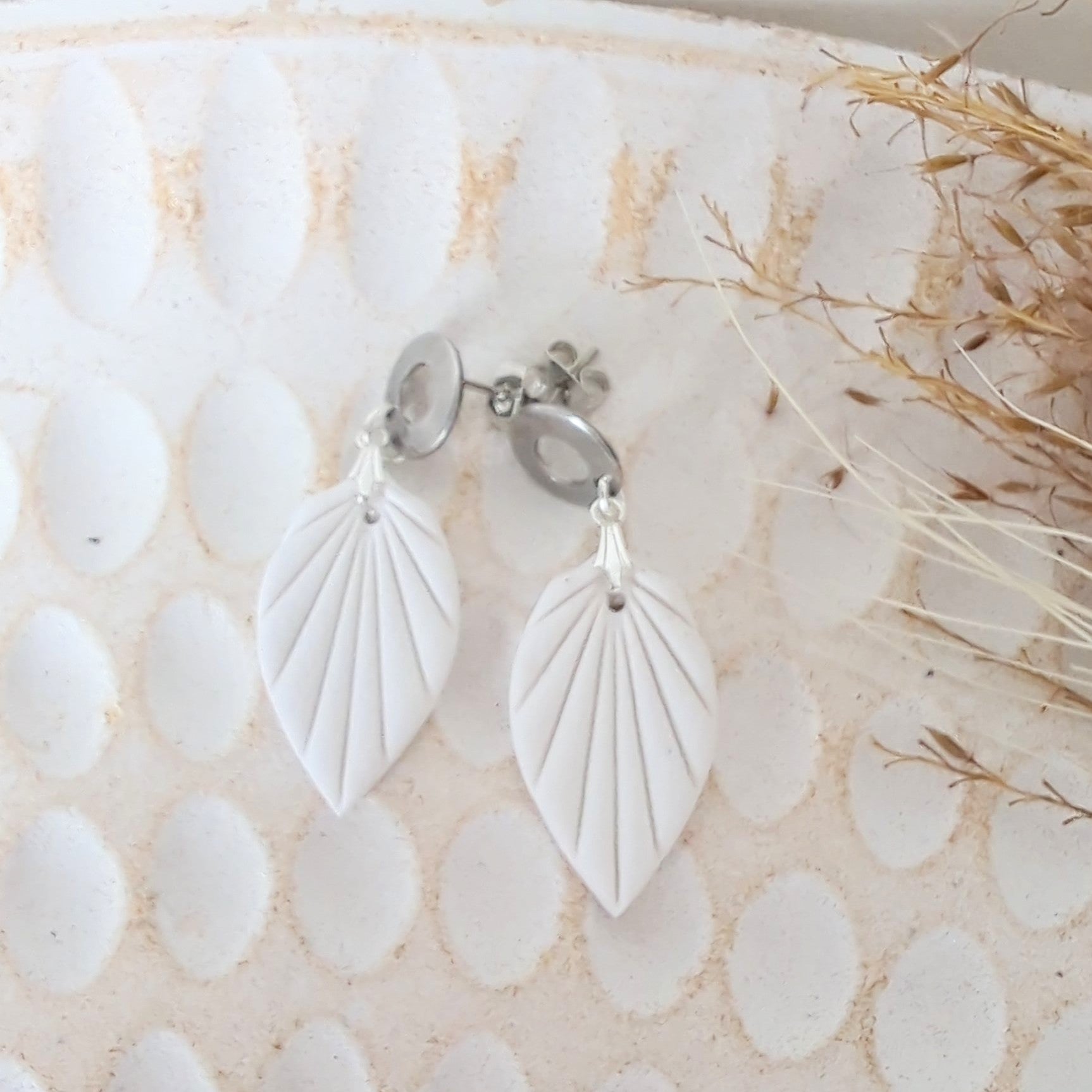 White Earrings with Silver in Different Designs.