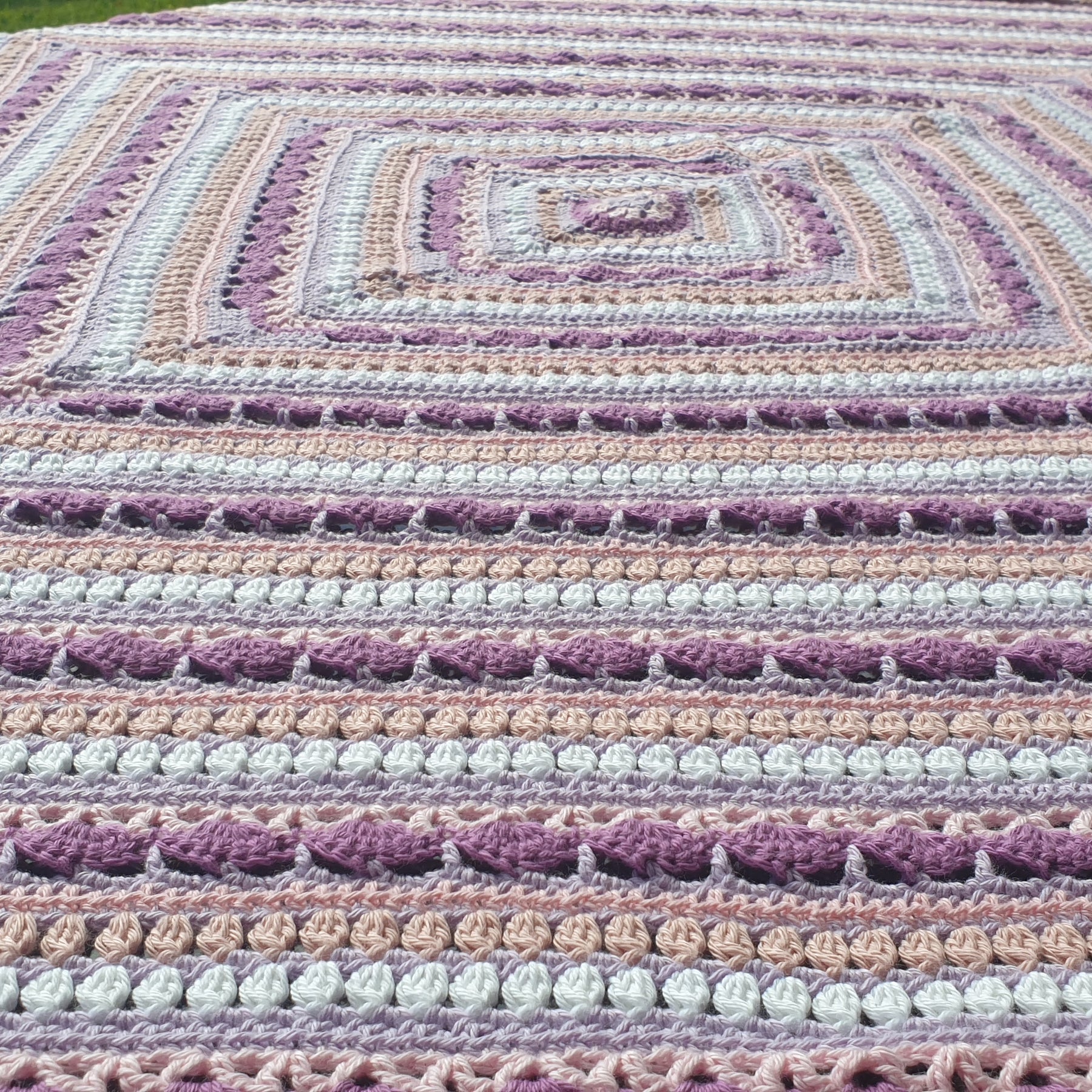 Beautiful crochet cotton afghan in pink/lilacs