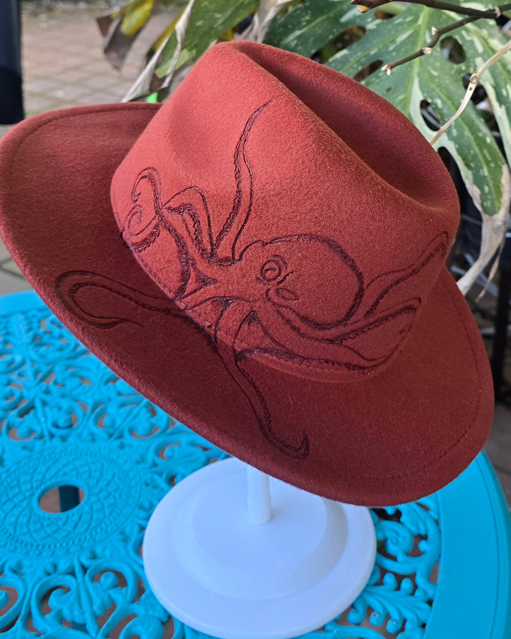 Rusty red fedora hat with hand burnt octopus.
