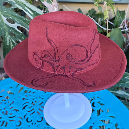 Rusty red fedora hat with hand burnt octopus.