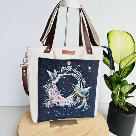 Modern hummingbird cross body bag featuring empowering words with ajustable strap