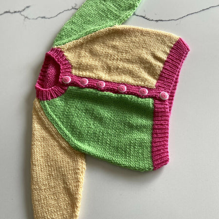 Hand knit baby cardigan with seam shaping and raglan sleeves size 0