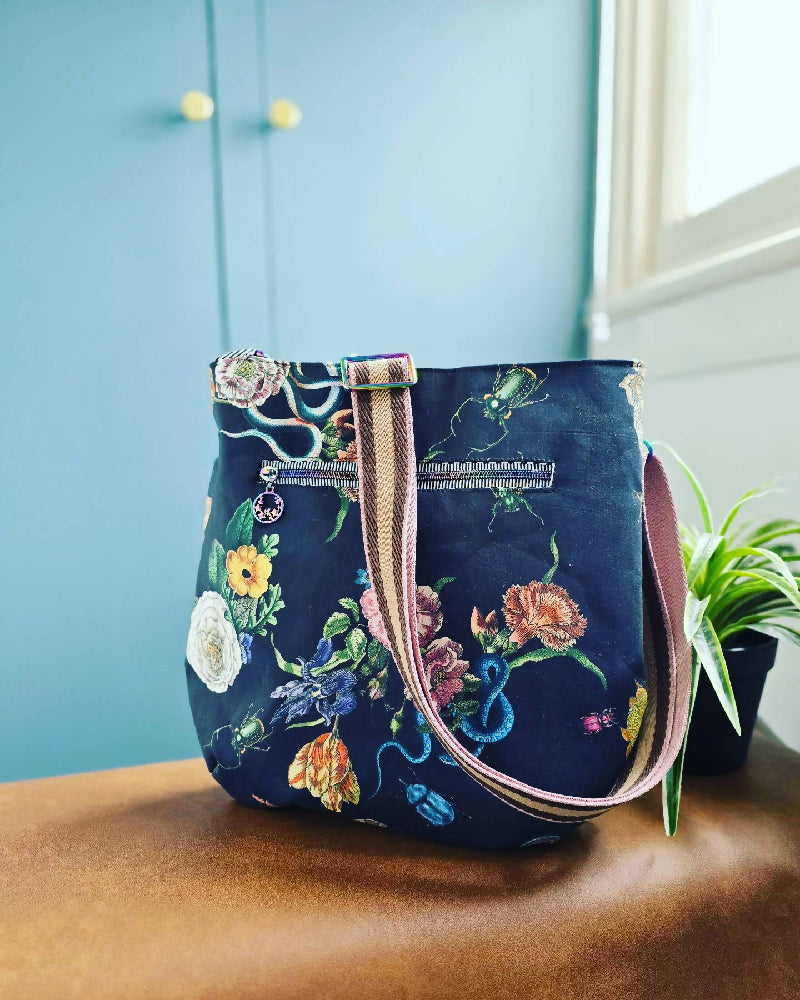 Large black crossbody bag. Snakes, bugs and flowers.