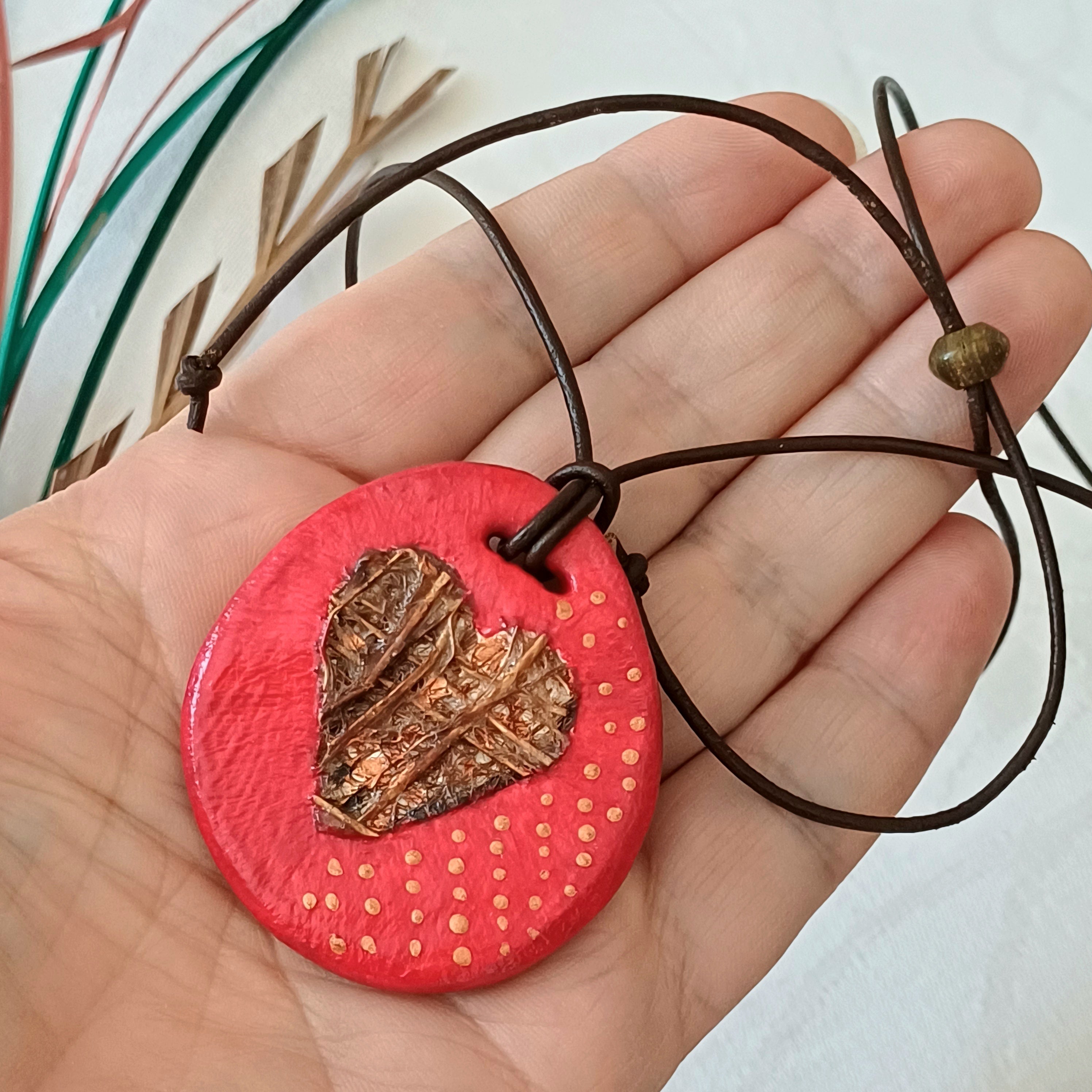 Hand-painted natural clay pendant with palm fibre heart