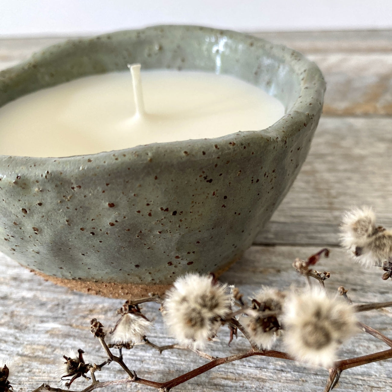 Soy candle in rustic sage green speckled ceramic bowl