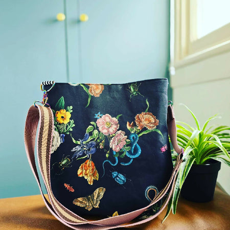 Large black crossbody bag. Snakes, bugs and flowers.