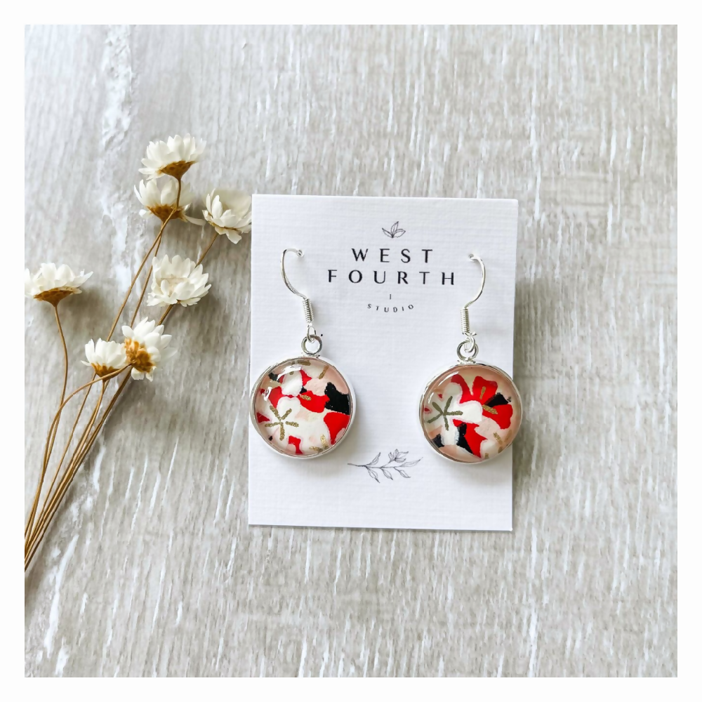 Statement earrings with a black, white, gold and red pattern