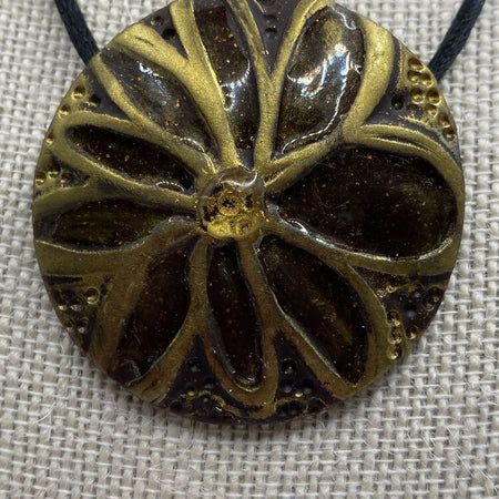 Black and gold round pendant on adjustable necklace