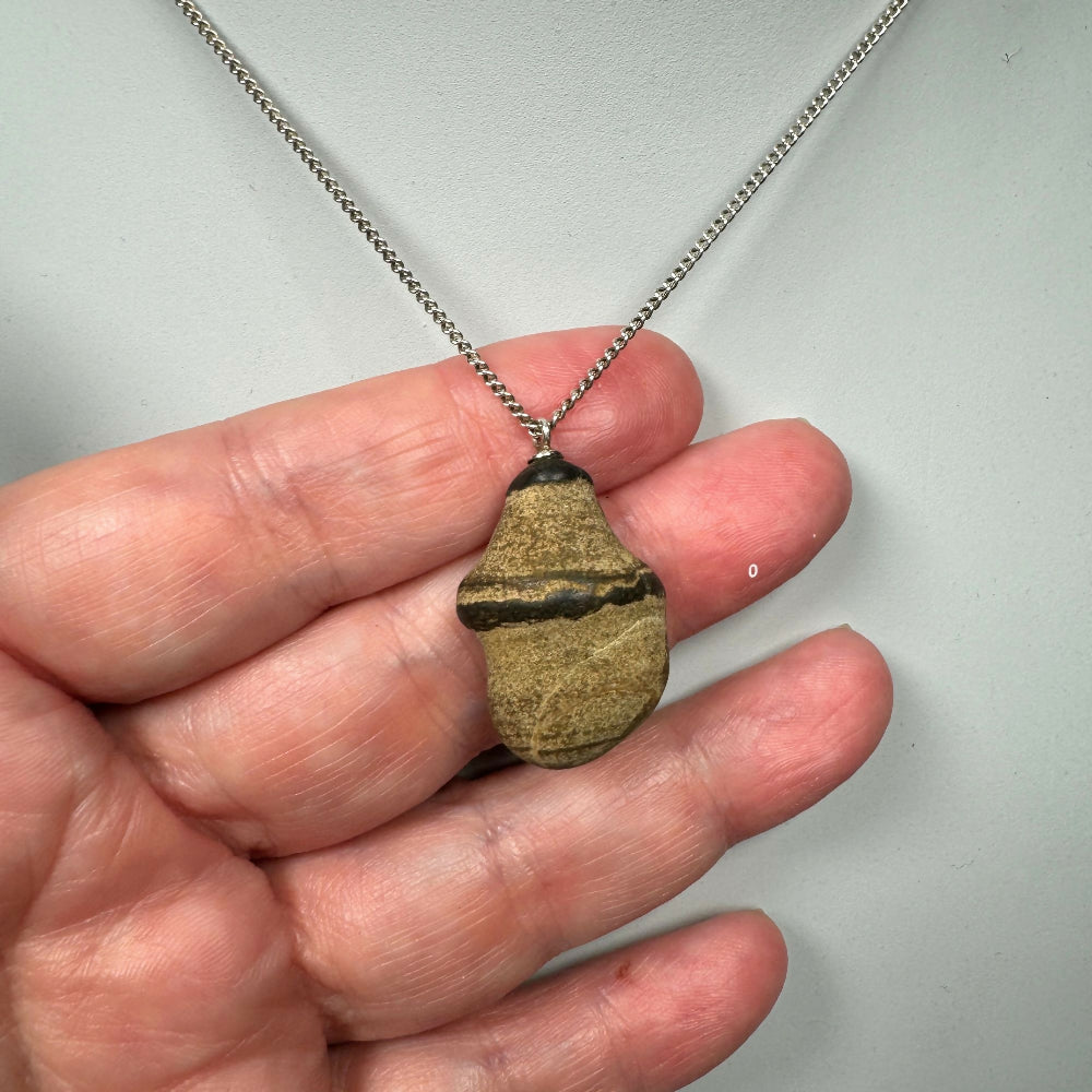 pebble necklace close up on hand