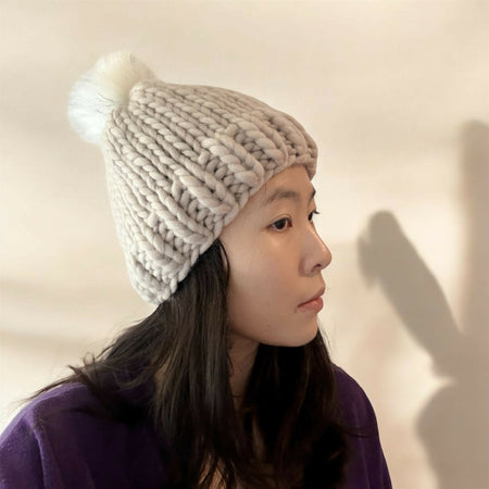 Super chunky hand knit merino wool light beige beanie with faux fur pompom