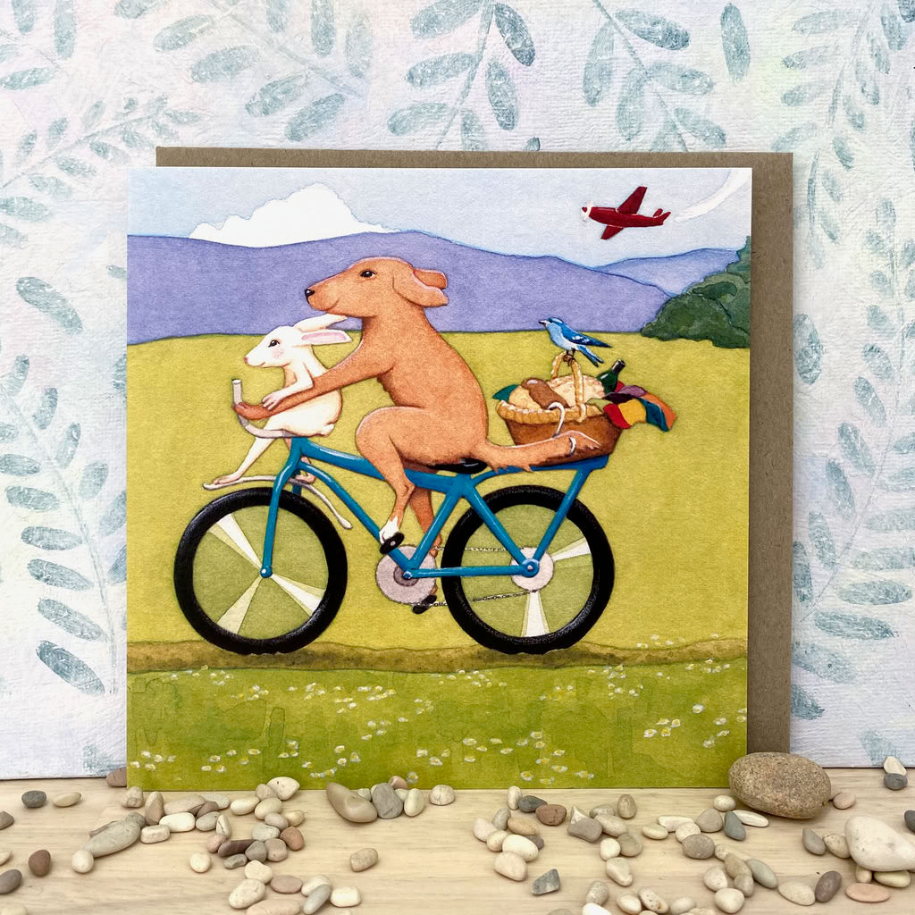Whimsical Dog and Rabbit on a Bicycle Eco-card (sq-perf)