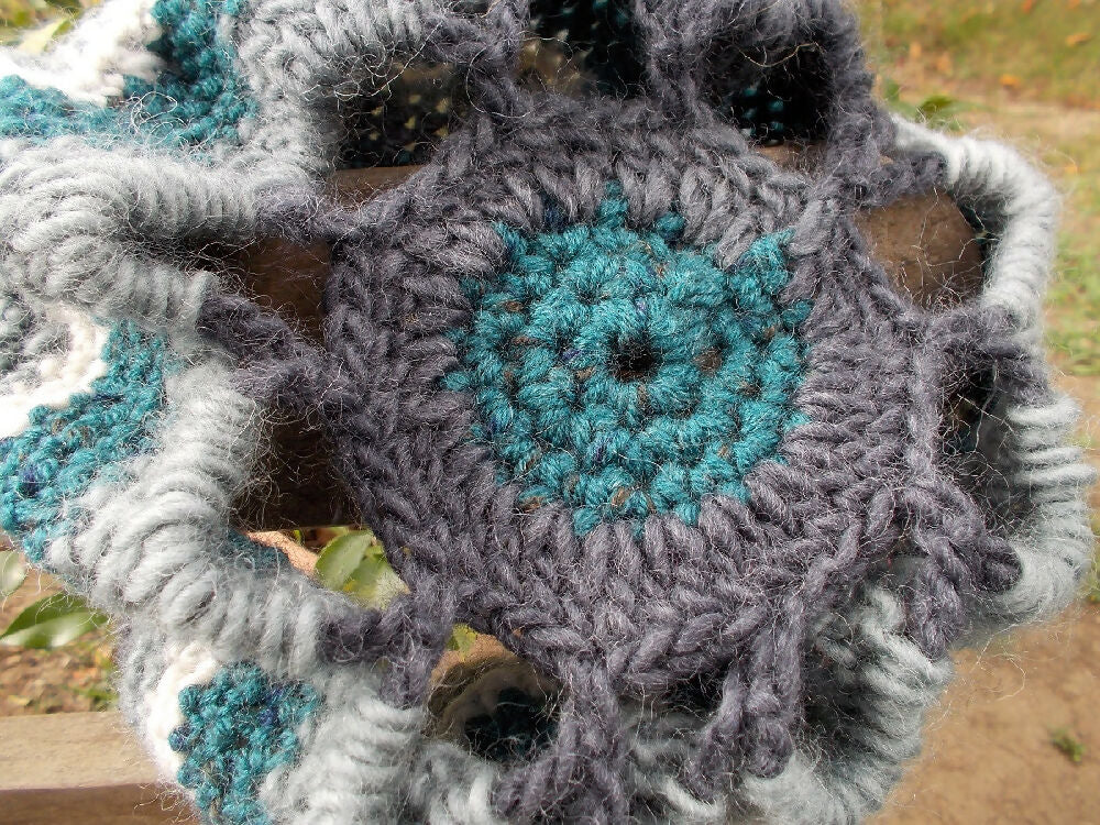 Crocheted winter hat in teal, grey and white wool