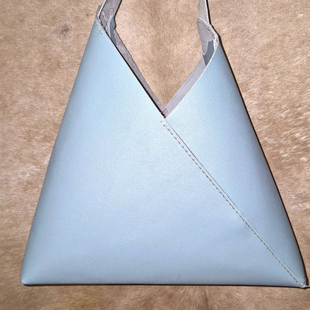 Light blue leather Saffiano triangular unlined handbag.