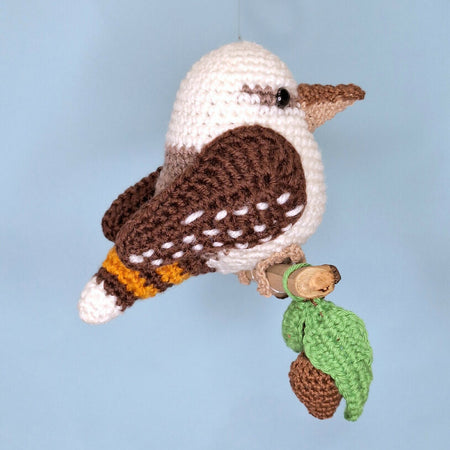 Crocheted laughing Kookaburra room decoration on perch