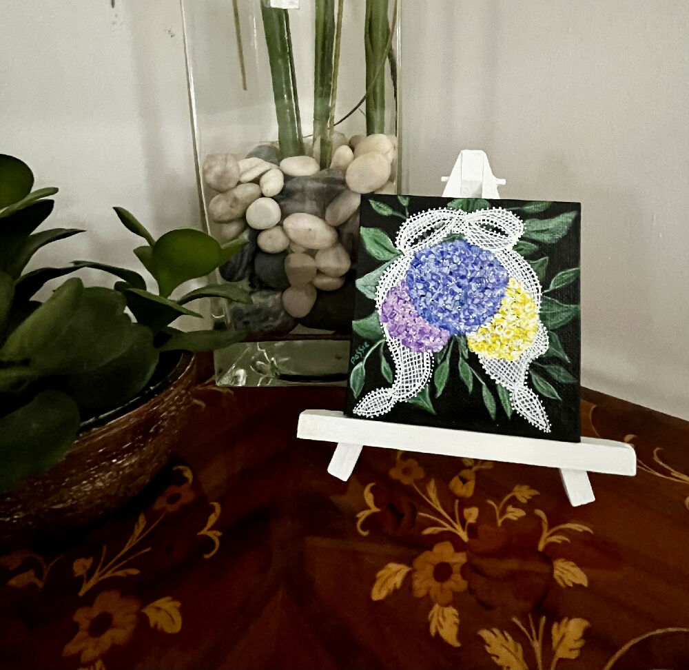 Miniature acrylic painting of flowers on a wooden easel