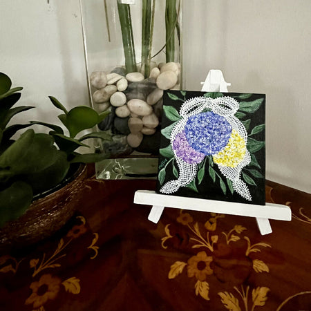 Miniature acrylic painting of flowers on a wooden easel