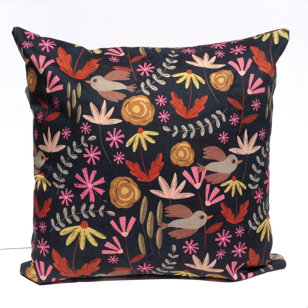 Floral cushion cover with bird detail.