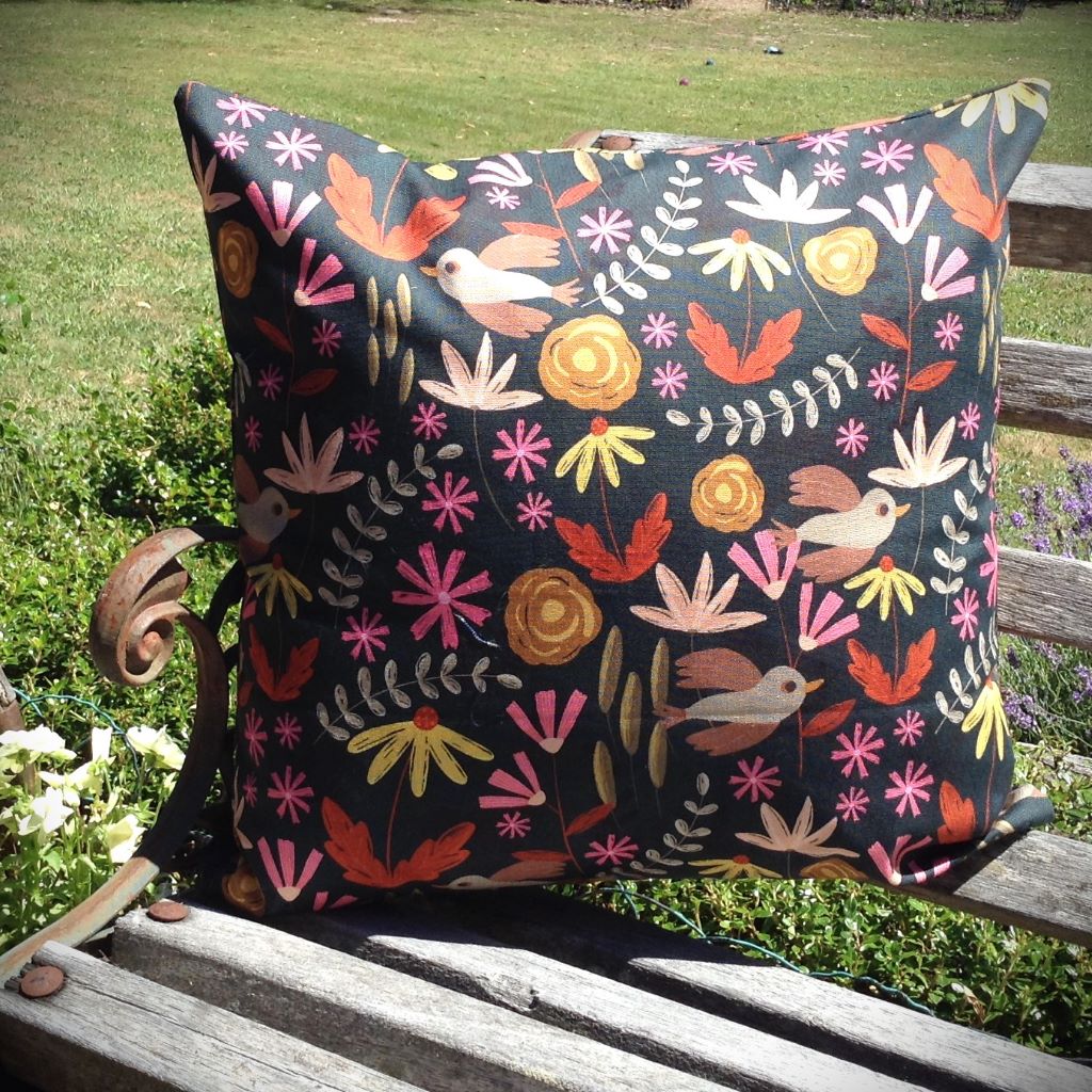Floral cushion cover with bird detail.