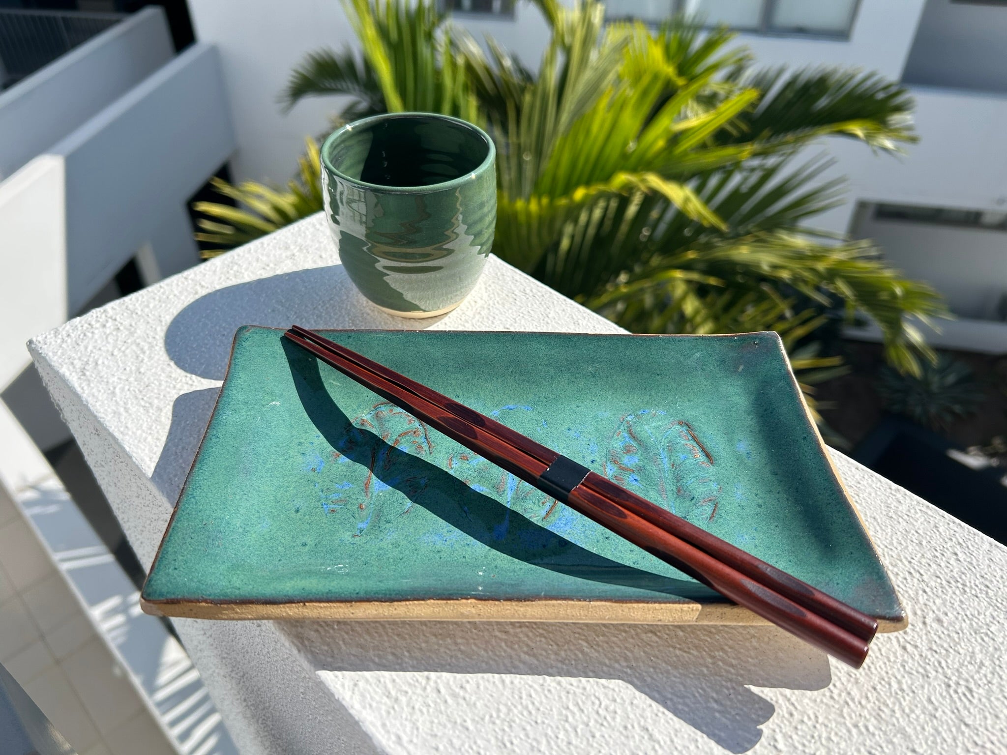 Ceramic Artisan-style sushi plate with a vibrant green glaze and leaf imprint.