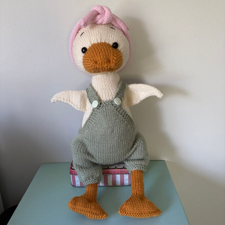 handknitted goose in overalls and headband
