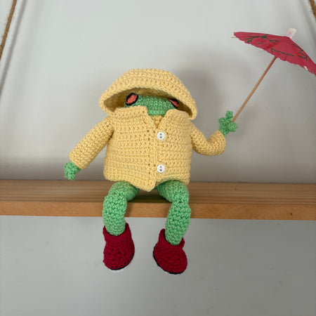 Frog in yellow raincoat and red boots
