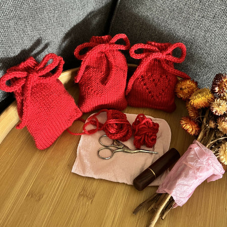 Hand knitted heart motif mini draw string bags