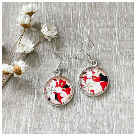 Statement earrings with a black, white, gold and red pattern