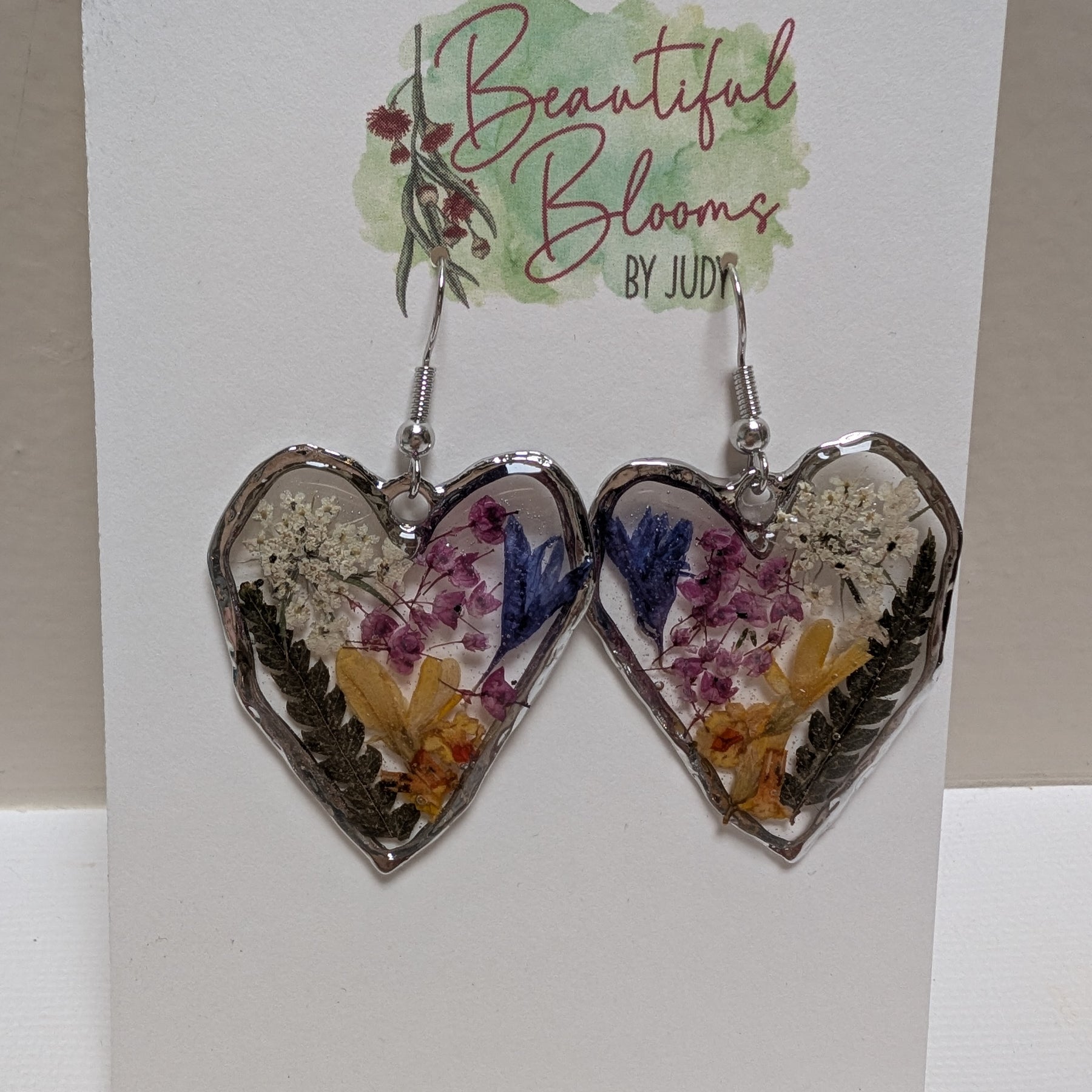 Pressed flowers in resin, heart-shaped, wildflowers