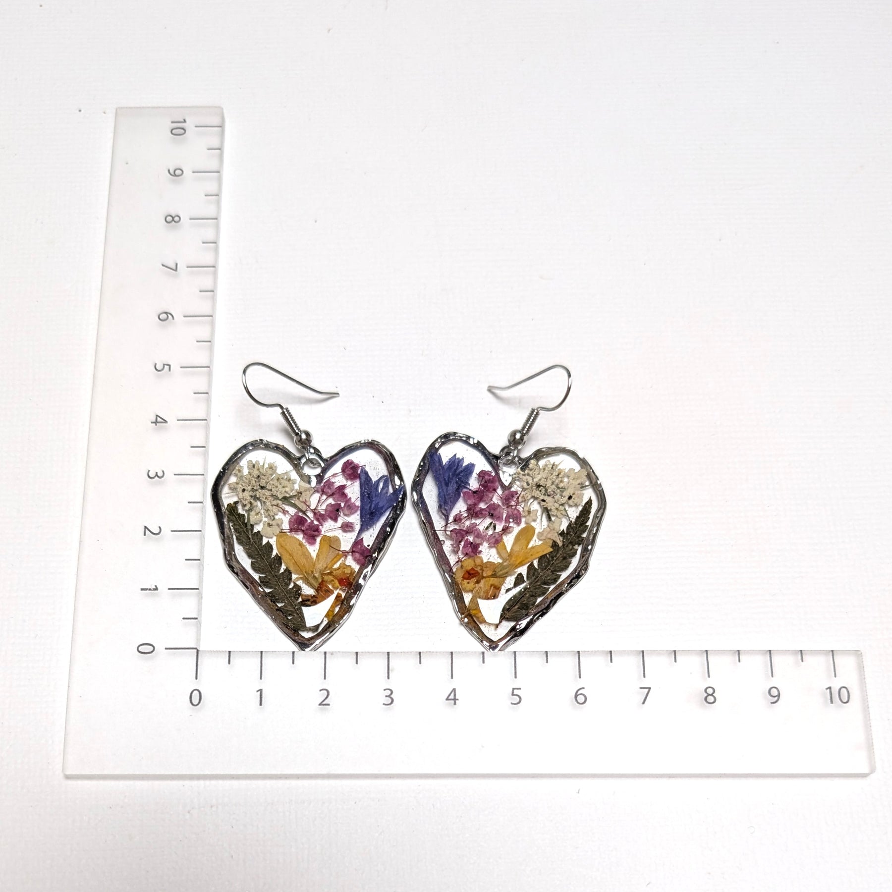 Pressed flowers in resin, heart-shaped, wildflowers
