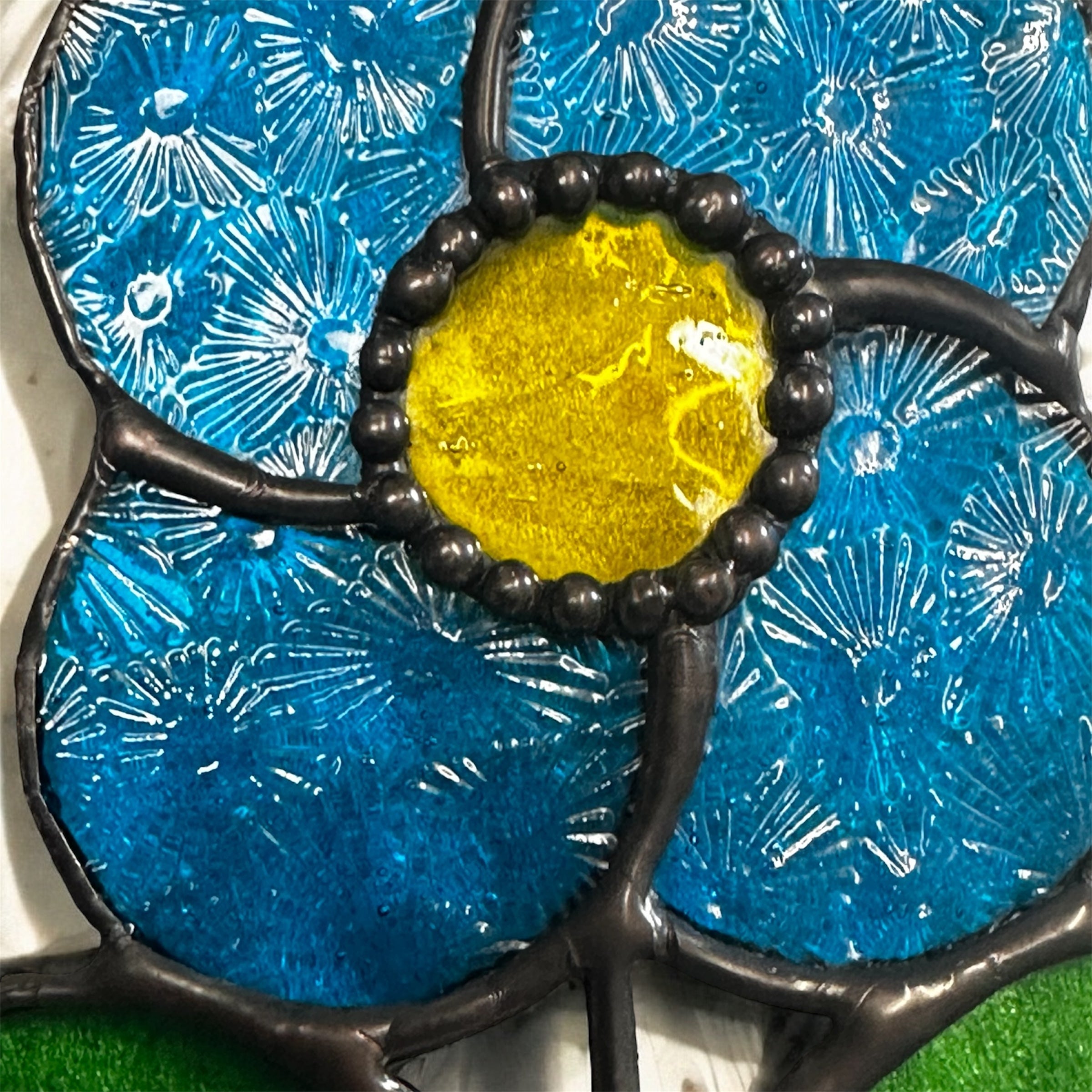 Bright blue flower spinning sun catcher
