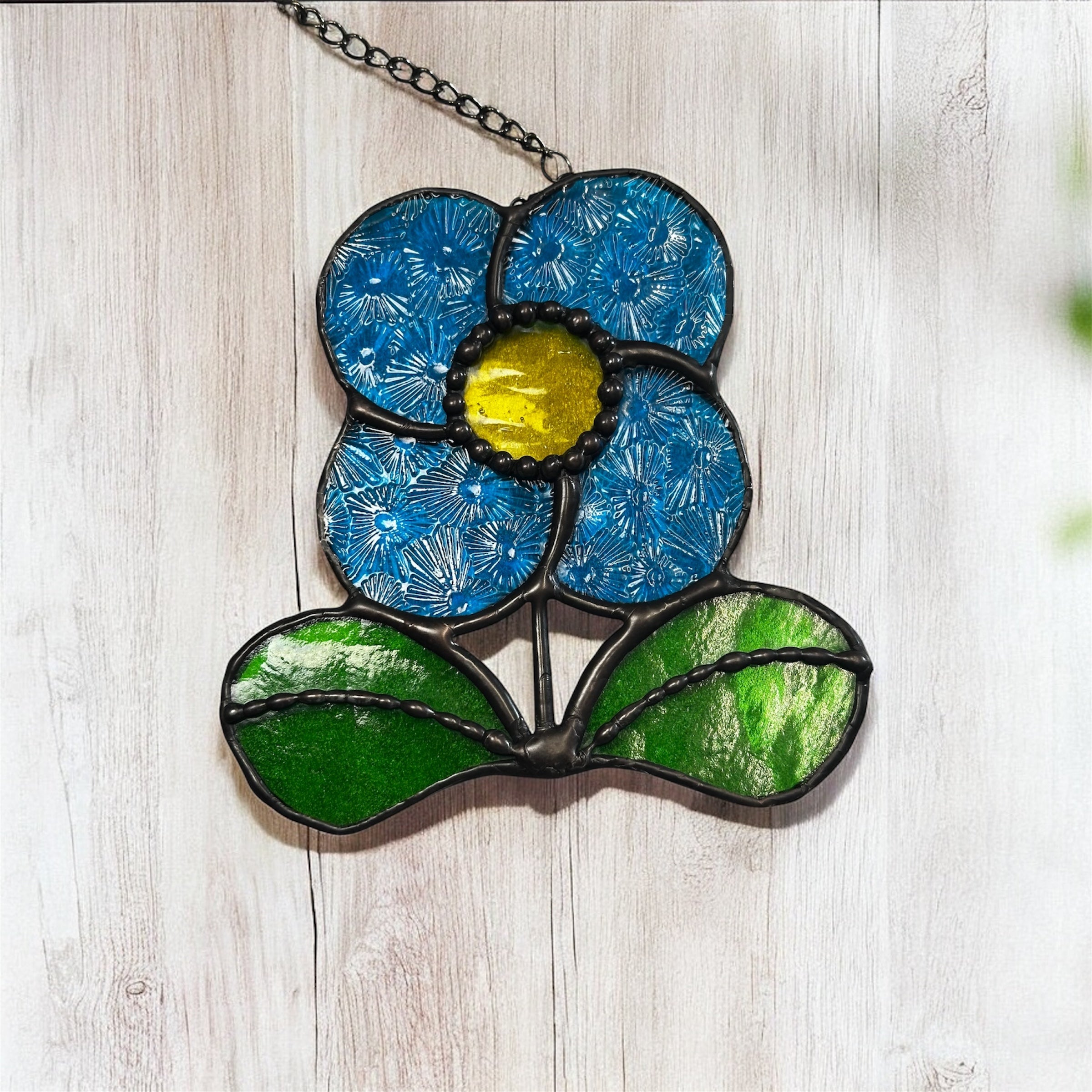 Bright blue flower spinning sun catcher