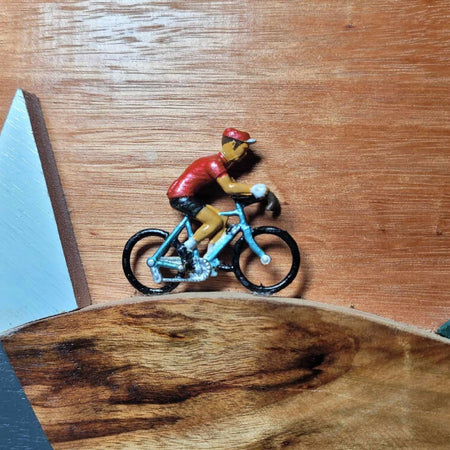 Retro vintage cyclist riding through a stylised mountain scene