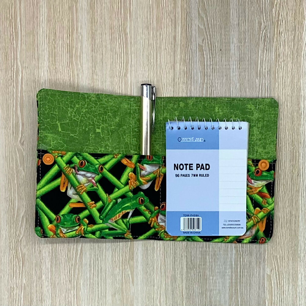 Green Frogs refillable fabric pocket notepad cover with snap closure. Incl. book and pen.